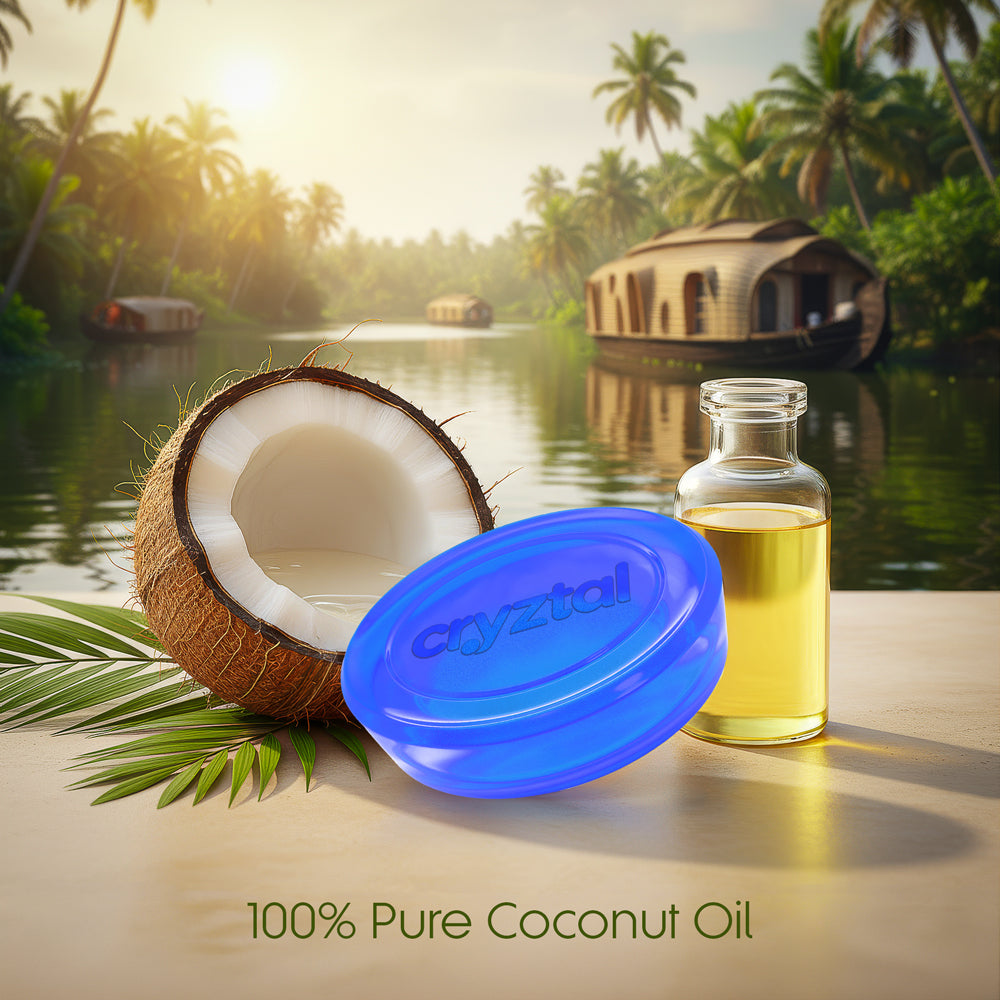 Coconut oil bottle with a blue lid and a half-coconut on a wooden surface with a tropical background.