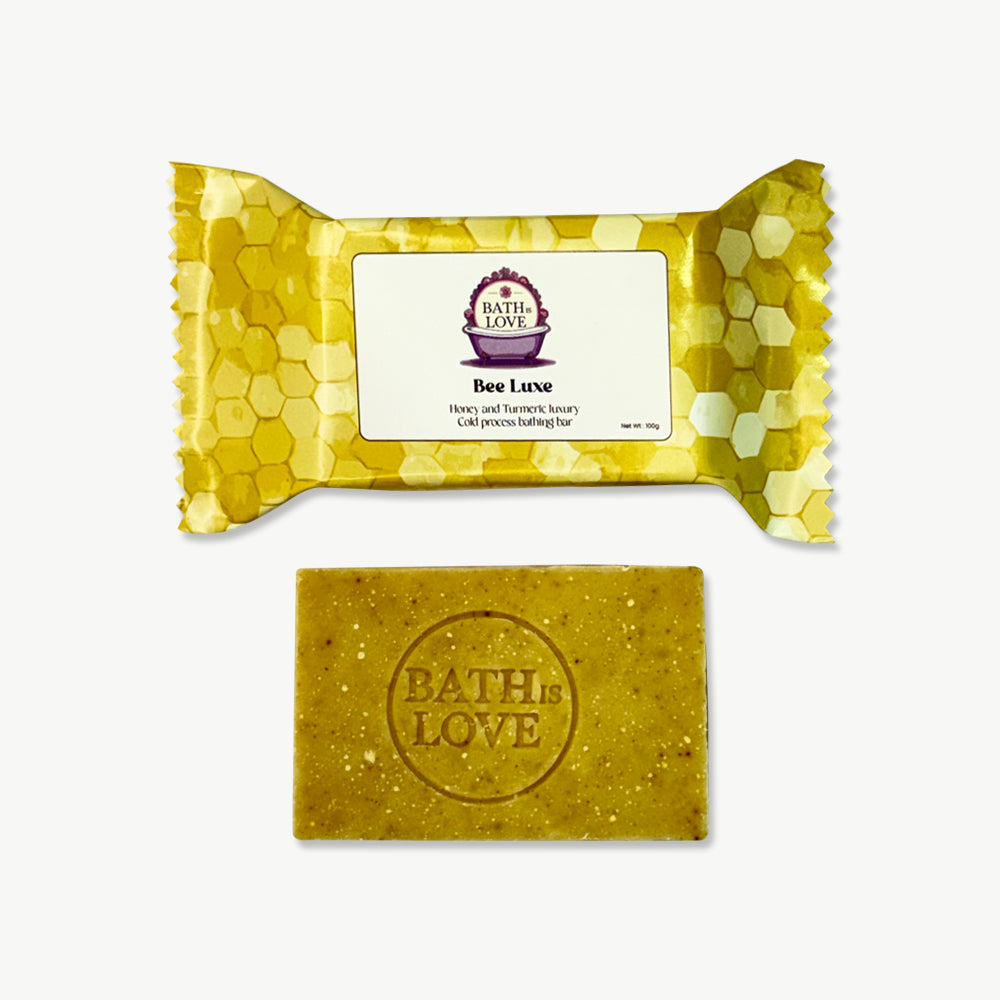 Bar of soap with a gold packaging featuring 'Bath of Love' branding on a white background.