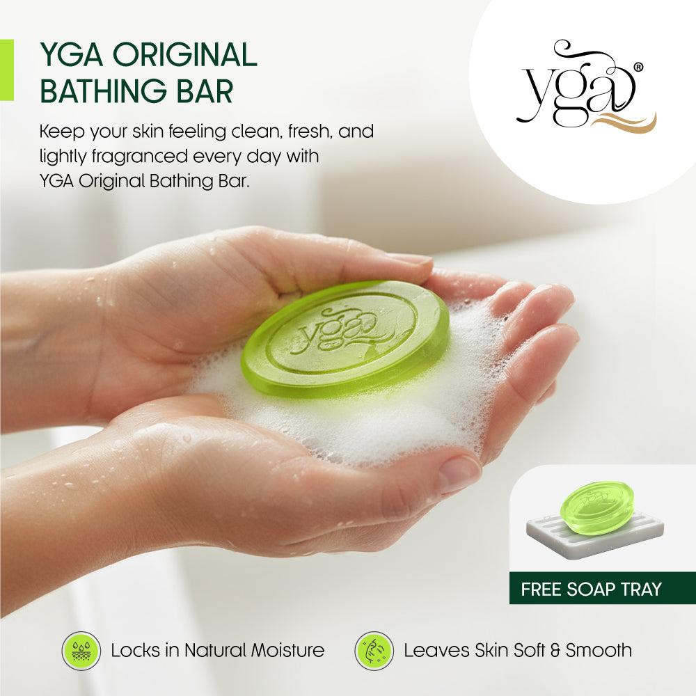 Green YGA Original Bathing Bar being held in hands with soap suds, brand logo visible.