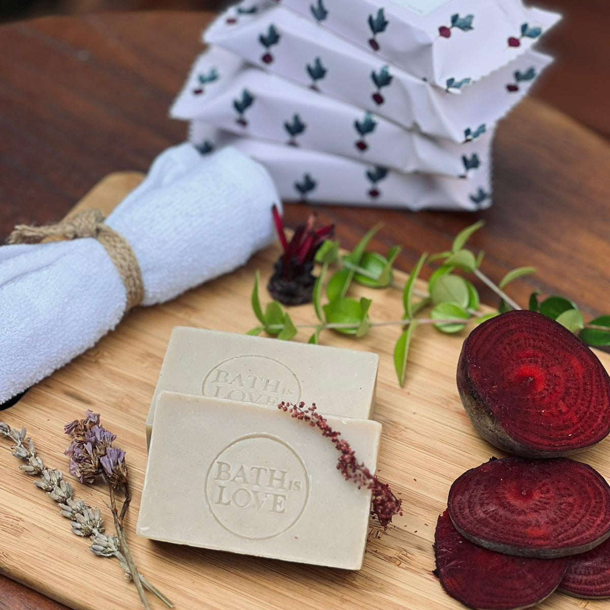 Bar of soap with 'Bath of Love' branding on a wooden cutting board with natural elements.