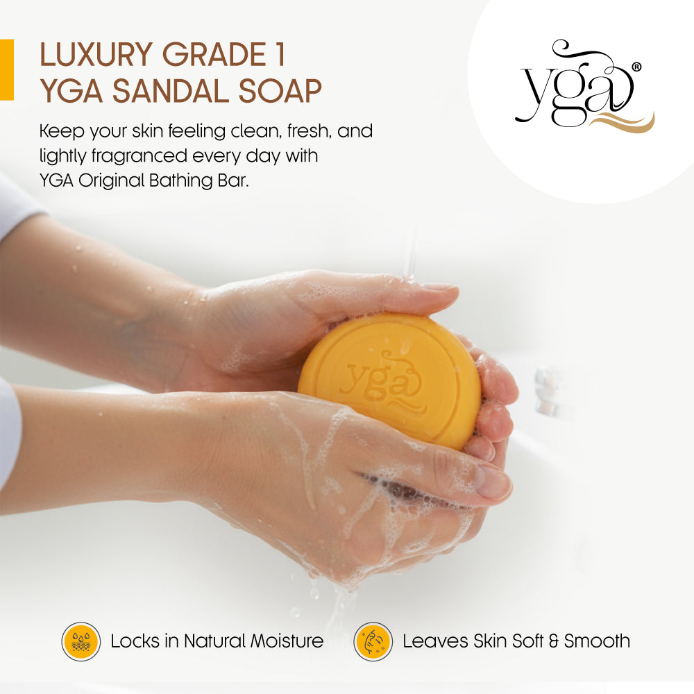 Close-up of hands lathering an orange YGA sandal soap bar under running water, with text highlighting moisture retention and soft, smooth skin benefits.
