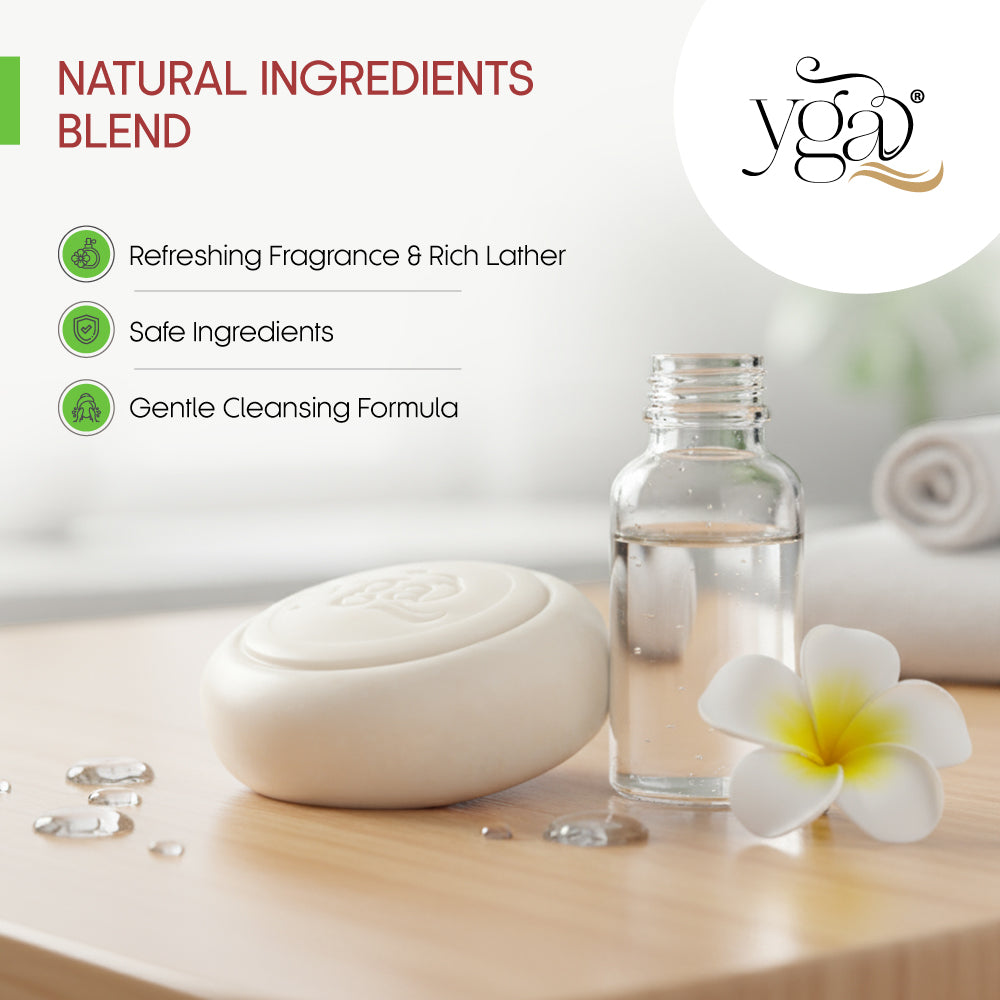 Yga natural ingredients blend with a bottle, soap, and flower on a wooden surface.